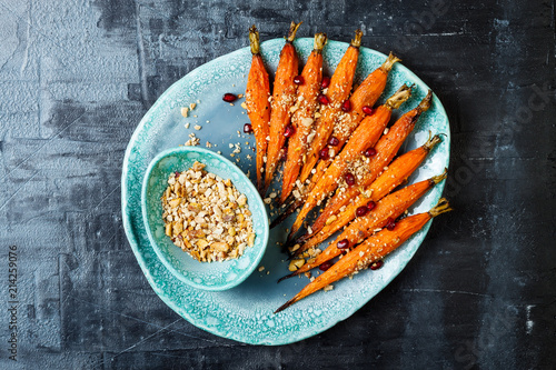 Roasted carrots with dukkah. Vegetarian food. Top view, flat lay, copy space photo