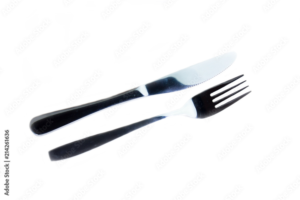 Metal fork and knife on a white background viewed from above Metal fork and knife on a white background viewed from above
