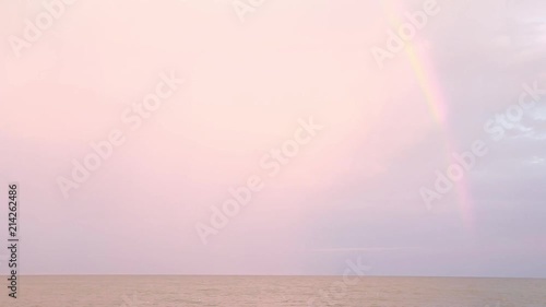 Sunset at sea, waves, sea breeze, beach. Rainbow after rain. photo