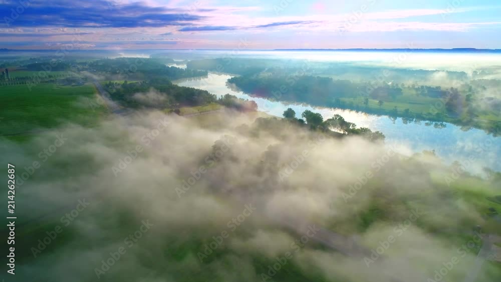 Scenic Wisconsin rural landscape with fog at sunrise, aerial flyover.
Scenic Wisconsin rural landscape with fog at sunrise, aerial flyover.