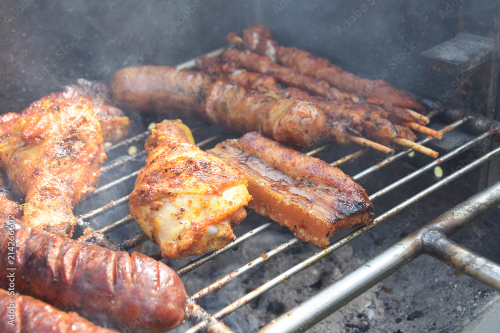 roasted chicken, sausage and bacon on the grill roasted chicken, sausage and bacon on the grill