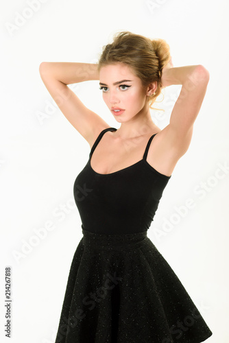 Beautiful makeup and black dress. Girl posing in black dress. Skin and face care. Girl in little black dress. Blonde girl making hairdo. Makeup. Beauty and fashion. Cosmetics for health.
