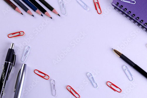 Various stationery in one color scheme on a bright paper purple background. Top view