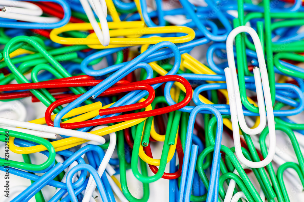 Colorful paperclips bunched up on a white surface. Colorful paperclips bunched up on a white surface.