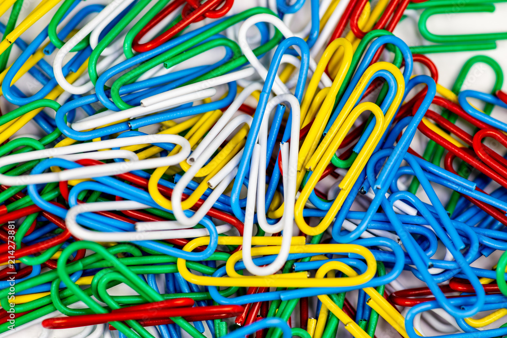 Colorful paperclips bunched up on a white surface. Colorful paperclips bunched up on a white surface.
