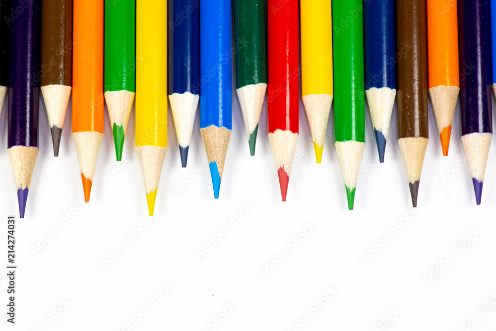 Color pencils lined up in a row against a white background. Color pencils lined up in a row against a white background.