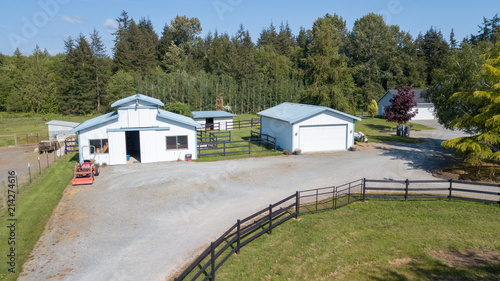 Drone view of the farm yard with barn, garage. © Javani LLC