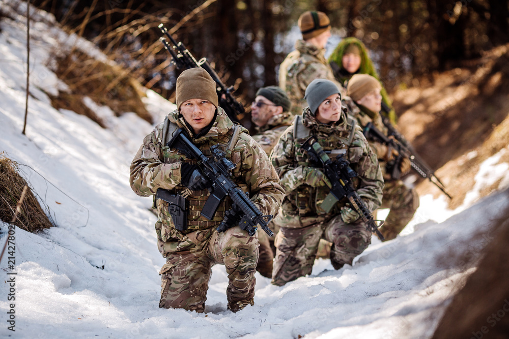 team of special forces weapons in cold forest. Winter warfare and military concept team of special forces weapons in cold forest. Winter warfare and military concept