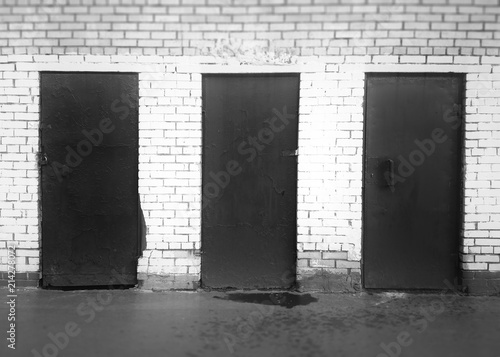 Three black and white closed doors background