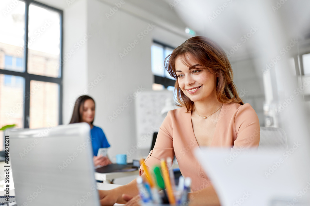 business, technology and people concept - smiling businesswoman with laptop computer working at office business, technology and people concept - smiling businesswoman with laptop computer working at office