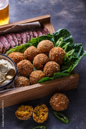 Falafel balls on a romano leafs in a wooden box