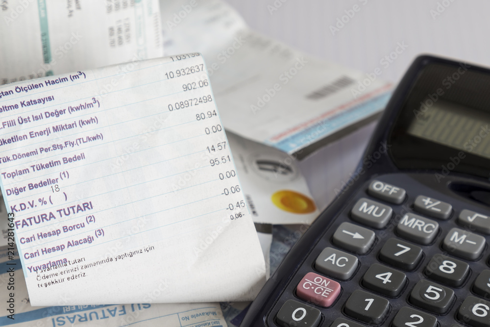 calculator and bills on the white background.the house account does not fit the bazaar. calculator and bills on the white background.the house account does not fit the bazaar.