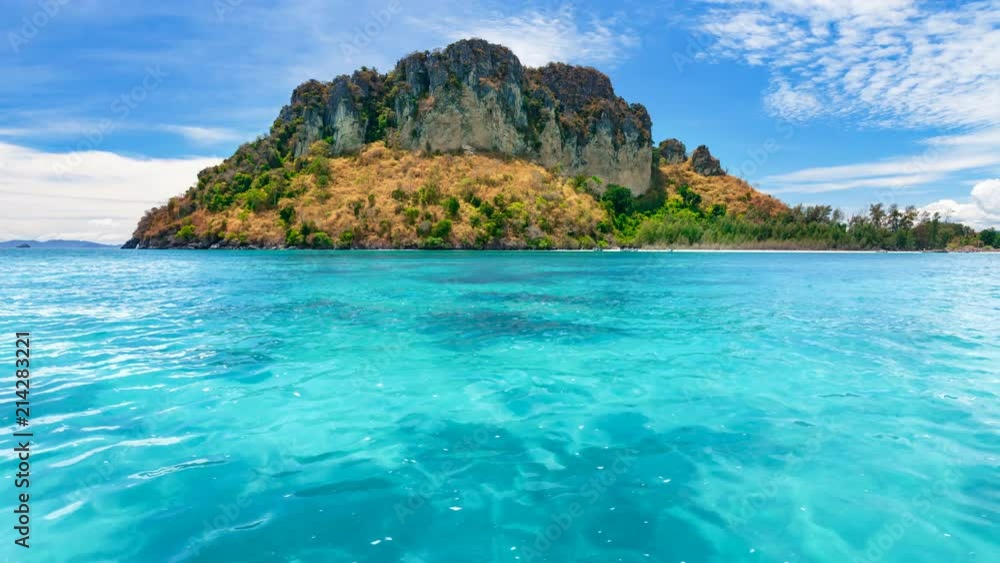 Tropical island coral reef with crystal turquoise water. Thailand. Nature landscape. Holidays, travel, vacation. Ocean water waves movement and clouds in sky float. 4K Slow Motion Time Lapse Parallax Tropical island coral reef with crystal turquoise water. Thailand. Nature landscape. Holidays, travel, vacation. Ocean water waves movement and clouds in sky float. 4K Slow Motion Time Lapse Parallax
