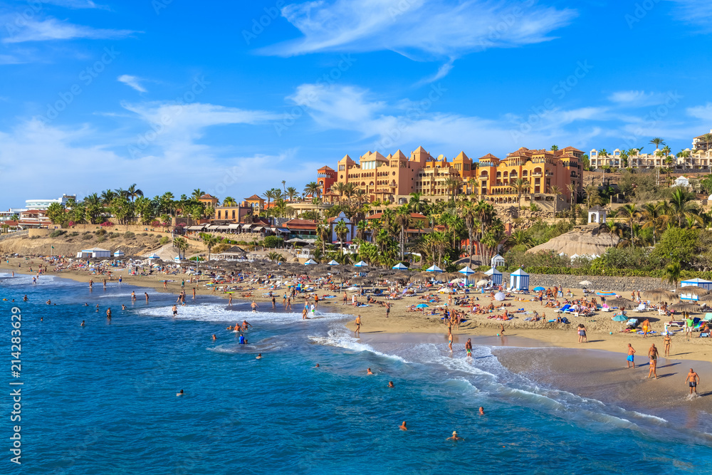 El Duque beach in summer holiday with people enjoying leisure life on Tenerife island - Spain