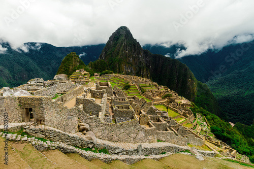 Citadel of Machu Picchu with mountain Huayna Picchu in background seen from the terraces