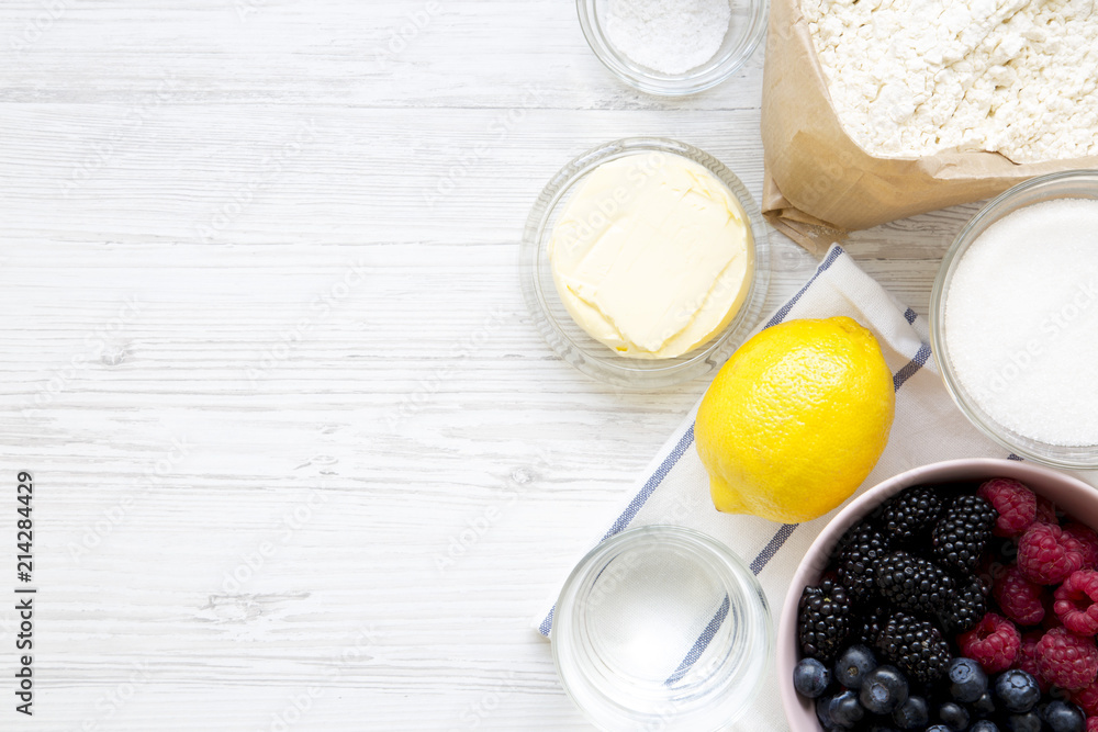 Raw ingredients: berries, lemon, flour, sugar, salt, water for cooking berry pie, top view. From above, overhead, flat lay. Copy space. Raw ingredients: berries, lemon, flour, sugar, salt, water for cooking berry pie, top view. From above, overhead, flat lay. Copy space.