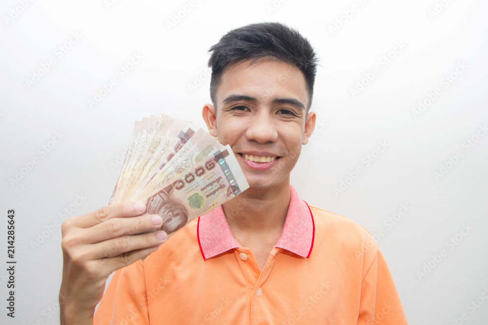 Asian young man holding money Thailand on white background Asian young man holding money Thailand on white background