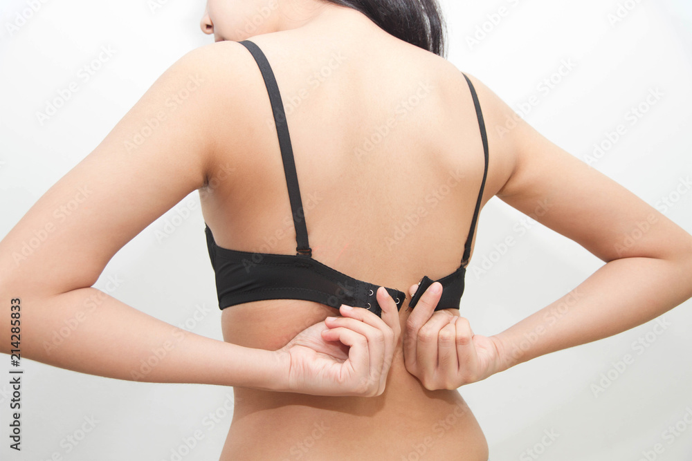 Woman back hand taking off or putting bra isolated on white background  Stock Photo