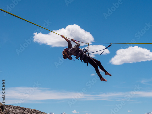 Fototapeta Naklejka Na Ścianę i Meble -  Girl hanging from highline in the Colorado mountains