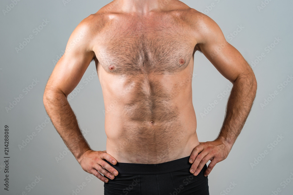 Muscular hairy male chest on grey background. Stock Photo | Adobe Stock