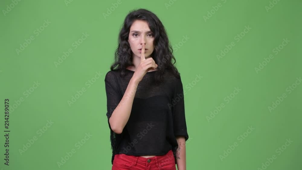 Young beautiful woman with finger on lips Young beautiful woman with finger on lips
