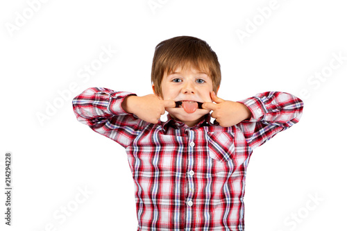 Young Boy With Shaggy Hair Makes a Funny Face With Tongue Sticking Out on White Background