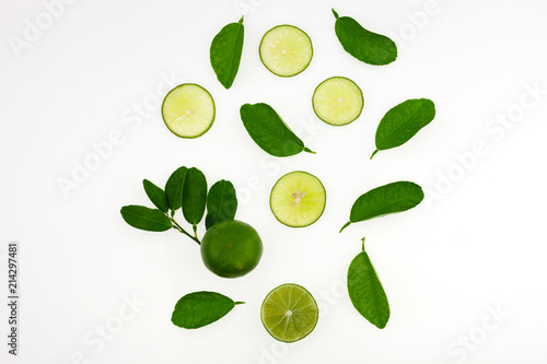 Top view of lime slices fruits and leaves isolated on white background