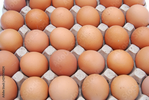 close up on brown eggs in egg box 