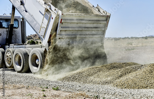 Dump Truck spreading Gravel on Driveway