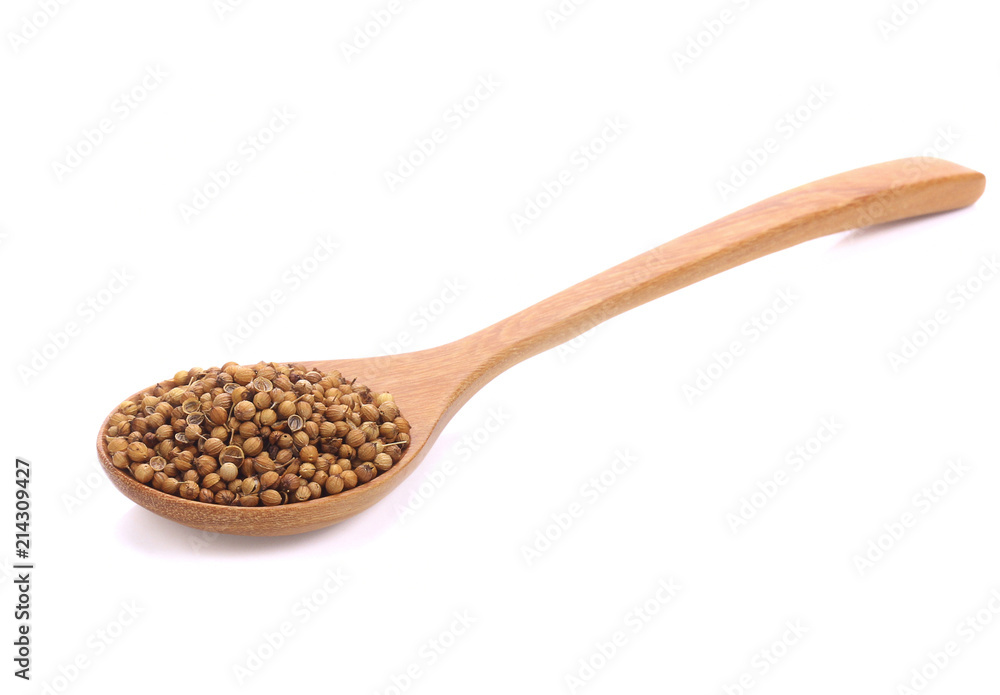 Coriander seeds in wooden spoon isolated on white background. Coriander seeds in wooden spoon isolated on white background.
