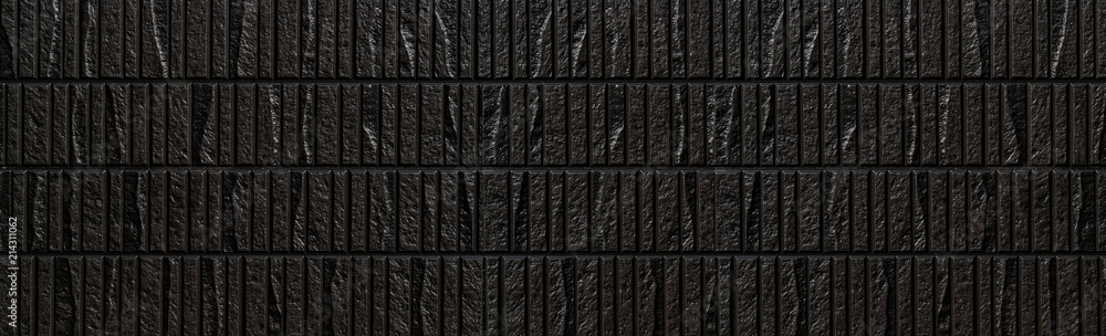 Fototapeta premium Panorama of Modern black stone tile wall pattern and background