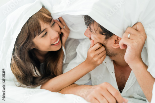 Happy young couple relaxing in the home bedroom. photo