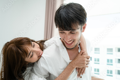 Happy young couple relaxing in the home bedroom. photo