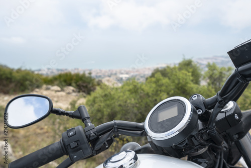 Motorcycle standing on a top mountain, near a coastline