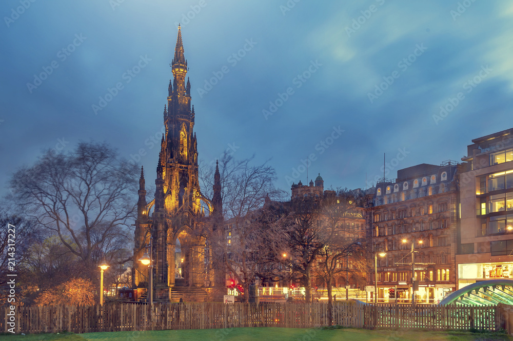 The Victorian Gothic building of Scott Monument to Scottish author, Sir Walter Scott, in Princes Street Gardens in old town Edinburgh, Scotland, UK, being lit up at night