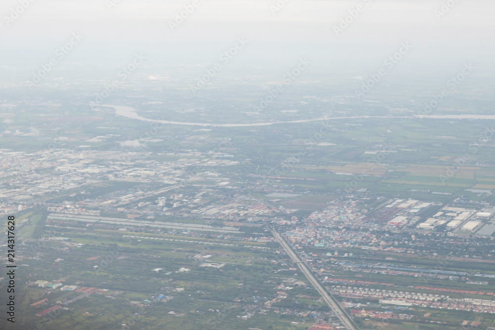 High angle photo of part of Bangkok, Thailand is taken from a plane’s window.