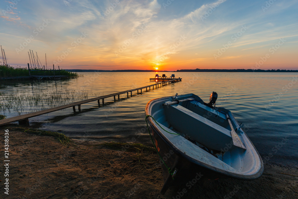 Sunrise landscape with rescue boat and wooden pier. Sunrise landscape with rescue boat and wooden pier.