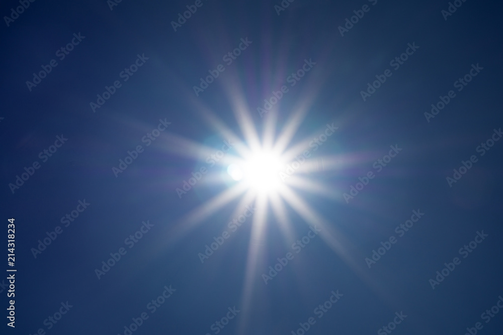 Shining sun at clear blue sky with copy space .