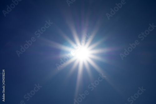 Shining sun at clear blue sky with copy space .