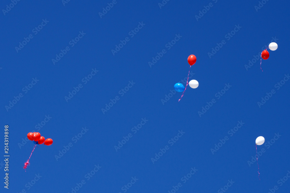 Fototapeta premium Group of multicolored helium filled balloons in the sky .