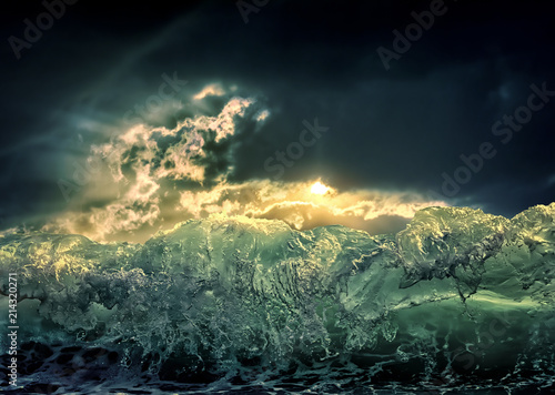 Dramatic dark ocean sea storm view with sun light clouds and waves. Abstract nature background. Climate concept. Extreme weather