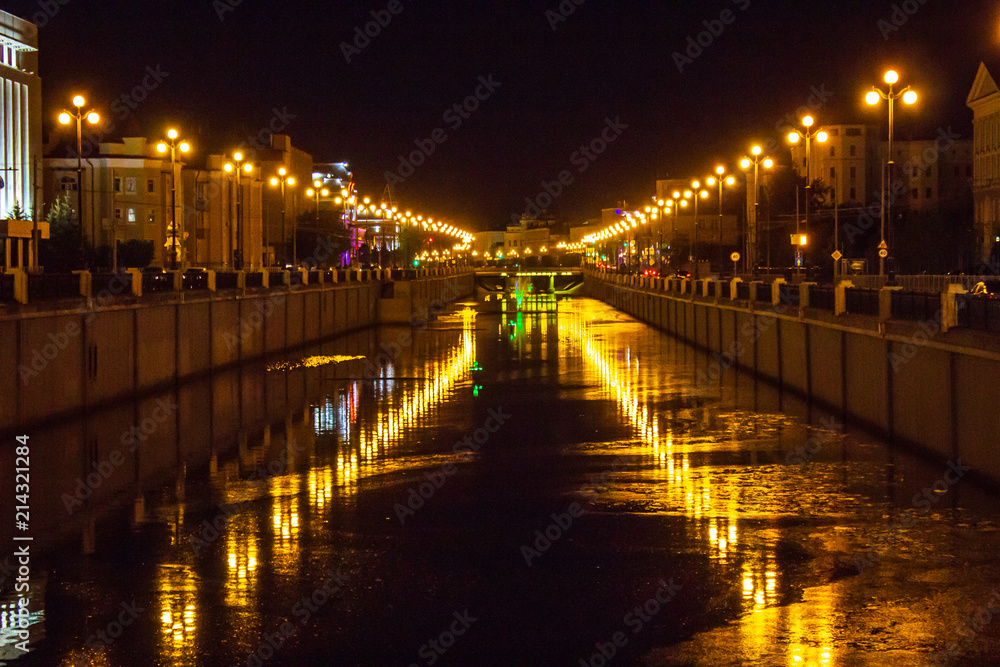 Night view of the street with lanterns and the Bulak canal, which reflects the lighting