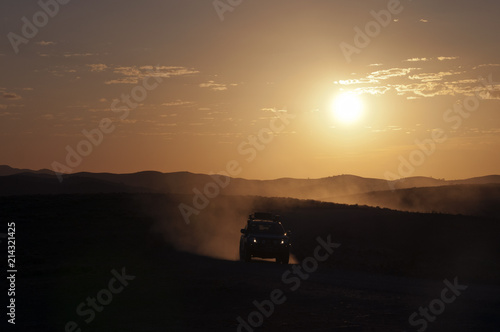 Stokes Hill lookout South Australia, 4WD approaching with sunset in background