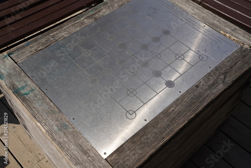 Checkers board game on a metal plate of the table