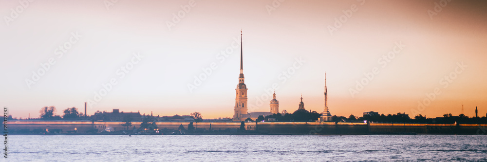Beautiful city night landscape, white nights in St. Petersburg, view of the Neva and Peter and Paul Fortress,  banner panorama format
