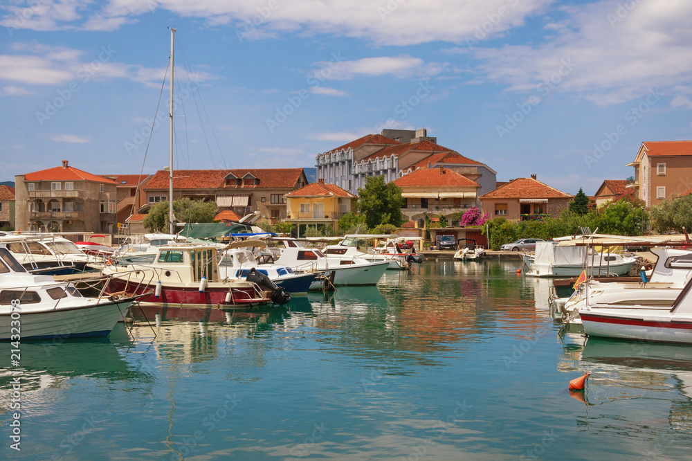 Sunny Mediterranean landscape with fishing boats in harbor. Montenegro, Tivat city, view of Marina Kalimanj
