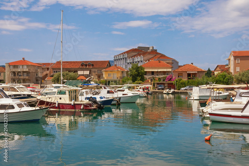 Sunny Mediterranean landscape with fishing boats in harbor. Montenegro, Tivat city, view of Marina Kalimanj