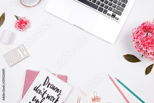 Woman workspace with laptop, handwritten quote notebook, pink carnation flower, smartphone,  lipstick on white background. Flat lay, top view. stylish female blogger concept. spring summer background.