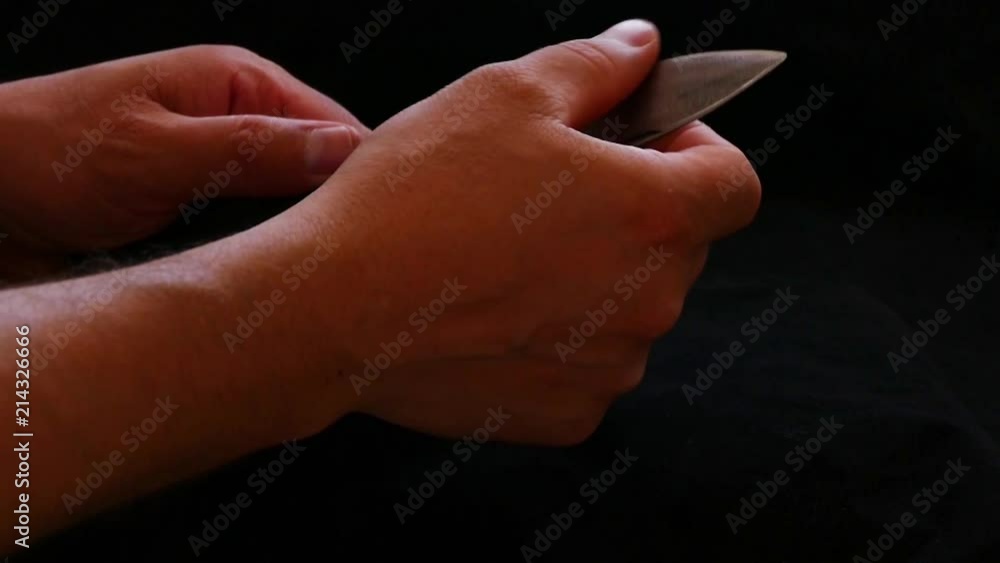 a person who controls a pocket knife.
a special turkish knife.
testing the sharpness of the blade on the black floor.
a person who controls a pocket knife.
a special turkish knife.
testing the sharpness of the blade on the black floor.