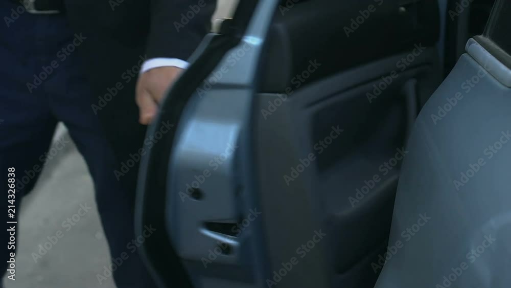 Personal chauffeur getting out of car and opening door to his boss, service Personal chauffeur getting out of car and opening door to his boss, service